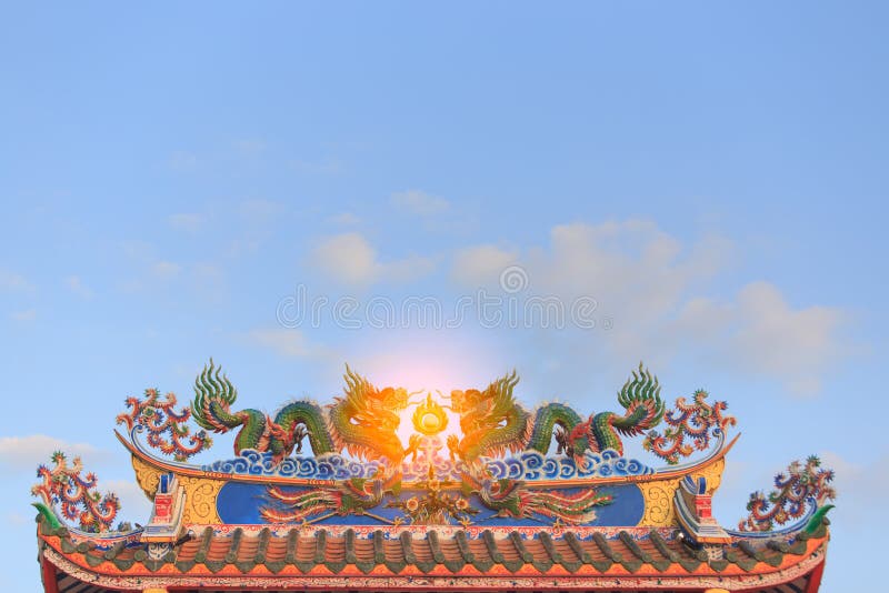 Twin dragons statue on the roof of Chinese temple stock photo Twin dragons statue on the roof of Chinese temple stock photo