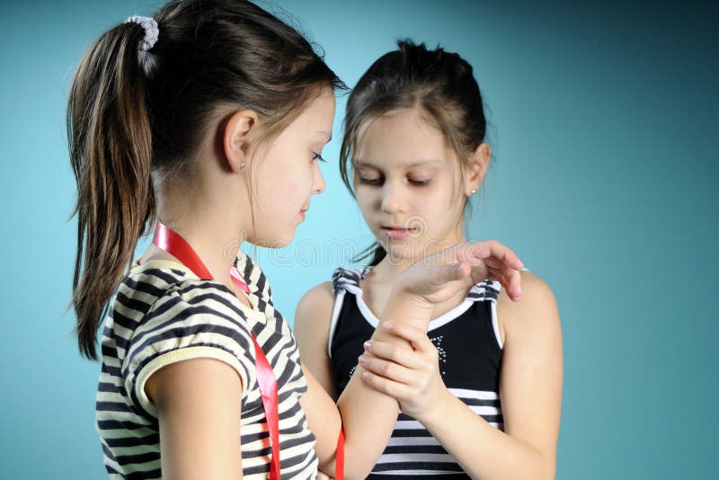 Twin girls practicing with red accessory