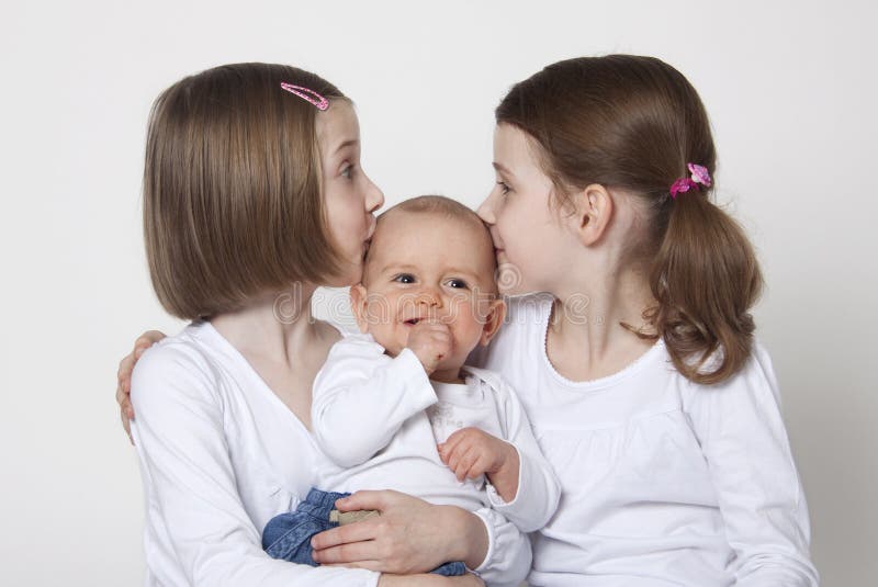 Twin sisters with baby boy brother