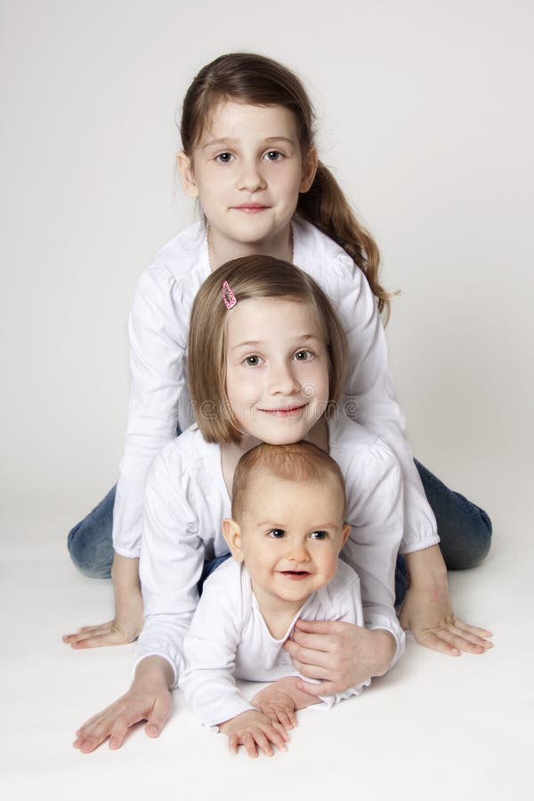 Twin sisters with baby boy brother