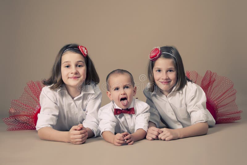 Twin sisters with little brother