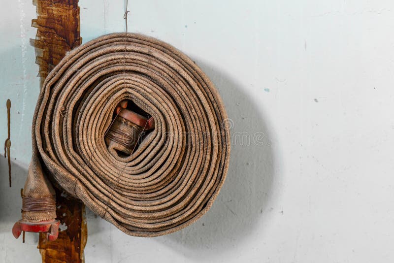 Twisted old rusty fire hydrant hose. Poor fire safety in the building royalty free stock photos