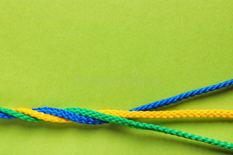 Twisted ropes on color background, top view.