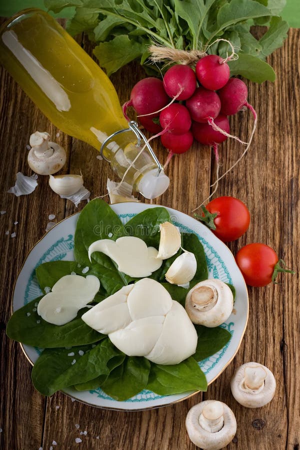 Twisted slovak cheese on plate with vegetable around