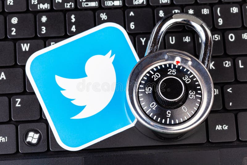 Twitter account password security simple abstract concept. Twitter service logo and a metal coded padlock, lock laying on a black