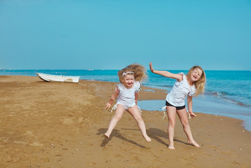 Two Adorable Sisters Plying On Sea Side Vacation Resort Hotel Side Stock Image Image Of Beach