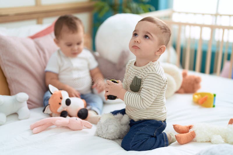 Two Adorable Toddlers Sitting on Bed Playing at Bedroom Stock Image Image of infants