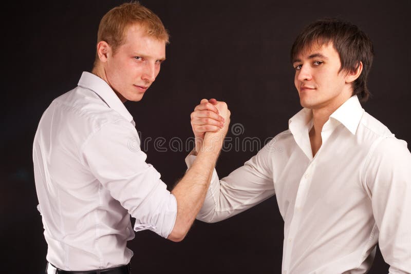 Two adult man in business hand shake