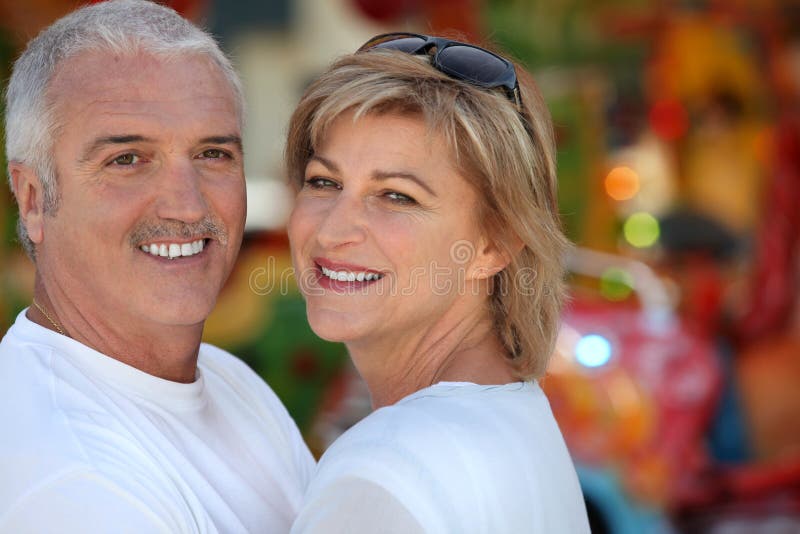 Two adults at funfair stock photo. Image of exciting - 23697246
