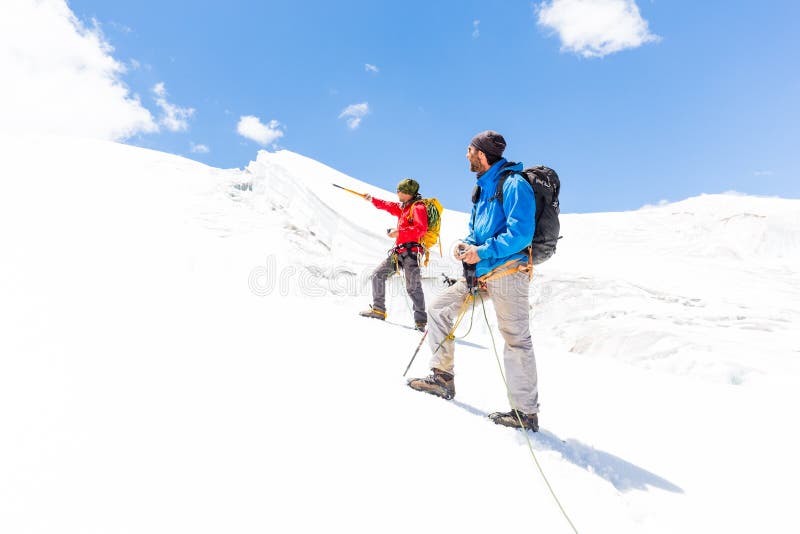 Two alpinists friends walking climbing ice glacier mountain Andes Peru