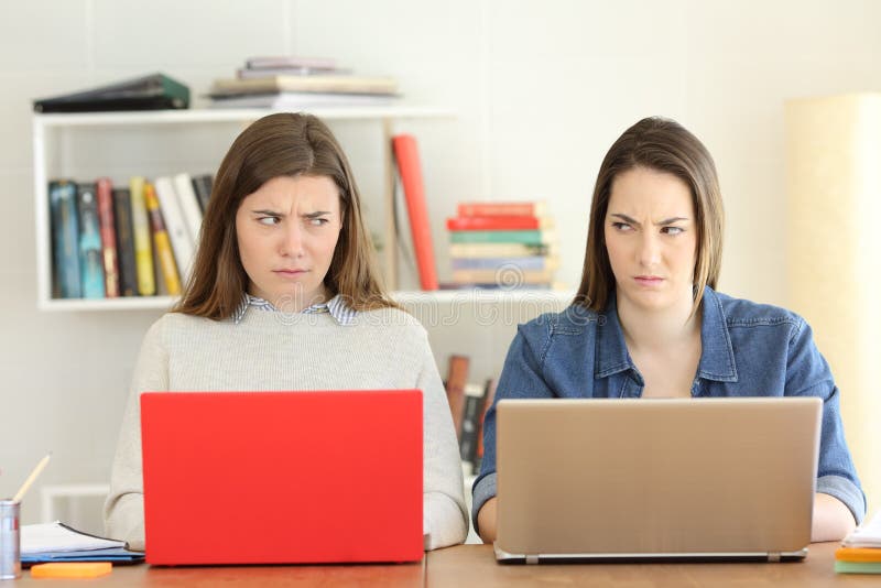 Two angry students looking each other with hate royalty free stock photography Two angry students looking each other with hate royalty free stock photography