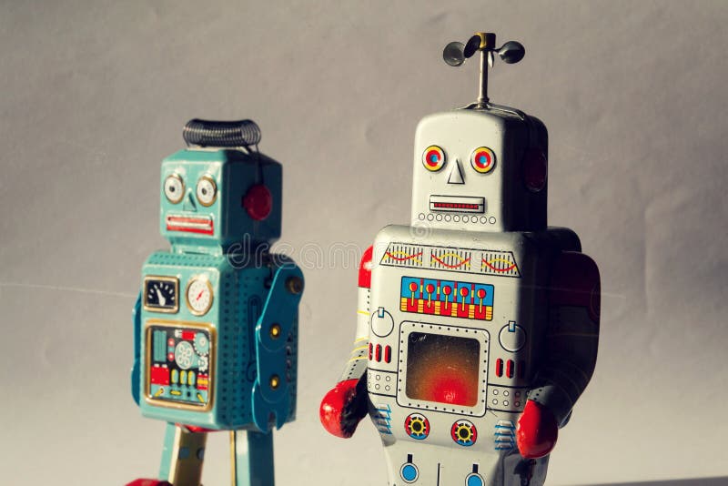 Two angry vintage tin toy robots, artificial intelligence, robotic drone delivery, machine learning concept royalty free stock images Two angry vintage tin toy robots, artificial intelligence, robotic drone delivery, machine learning concept royalty free stock images