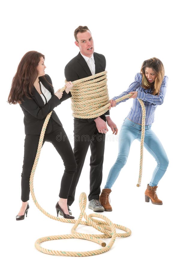 Two angry woman tying a business man with rope royalty free stock photo.