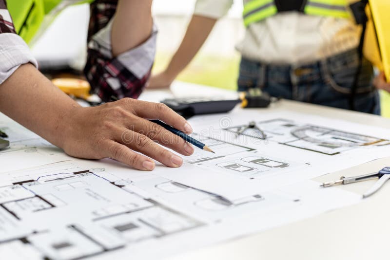 An Architect a Home Design Engineer is Drafting a House Plan for a