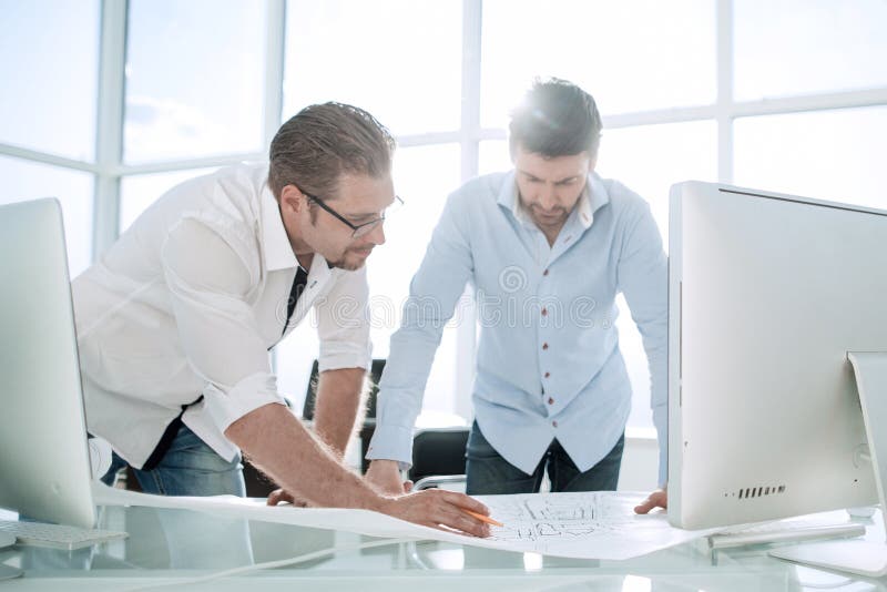Two Architect working with blueprints for architectural plan. stock images