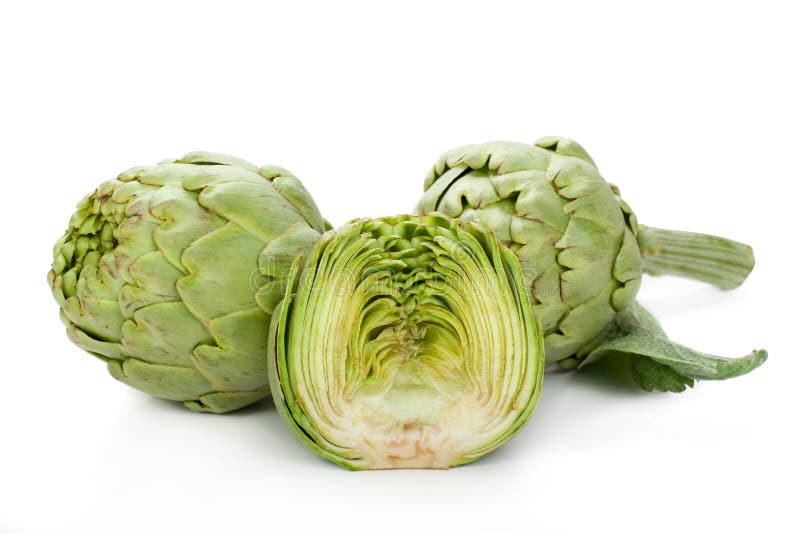 Two artichokes and a half. Two fresh artichokes with stem and leaf and a half showing the heart stock photos
