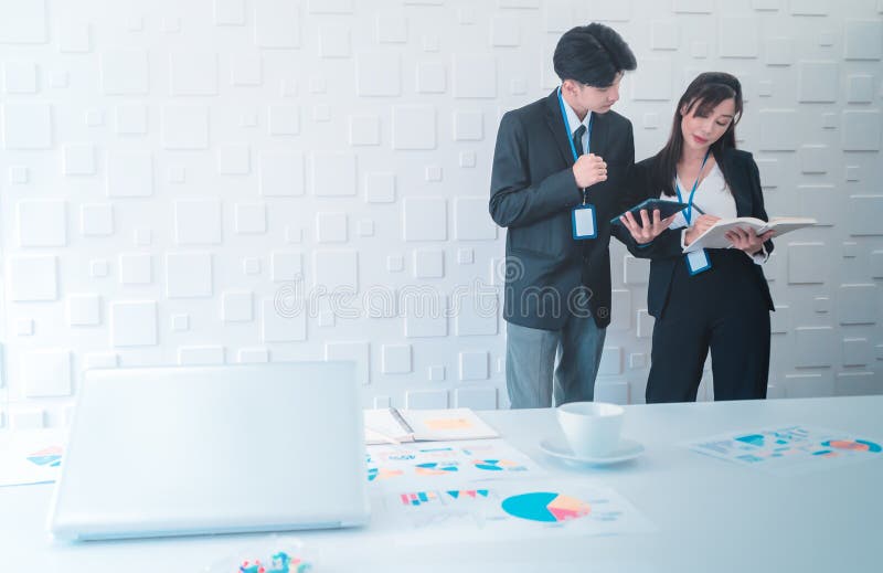 Two business people is discussing on laptop and tablet with white copy space stock images