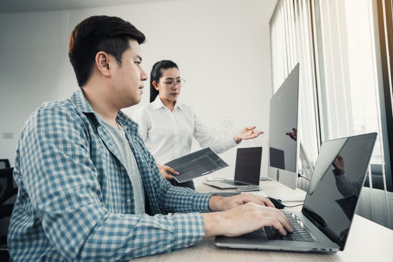 Two asian team working development of programming and encryption technology website design programmers on desk in office royalty free stock photography