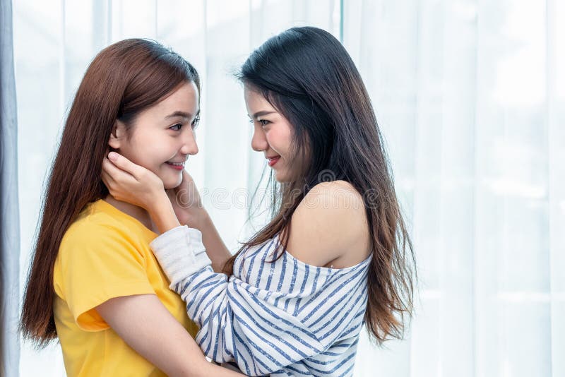 Two Asian Women Looking at Each Others in Home