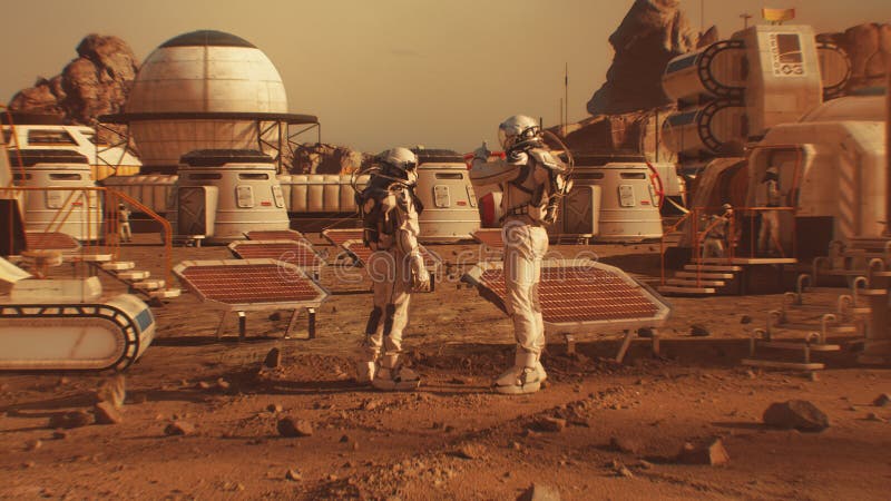Two astronauts walk toward research station on Mars royalty free stock photography