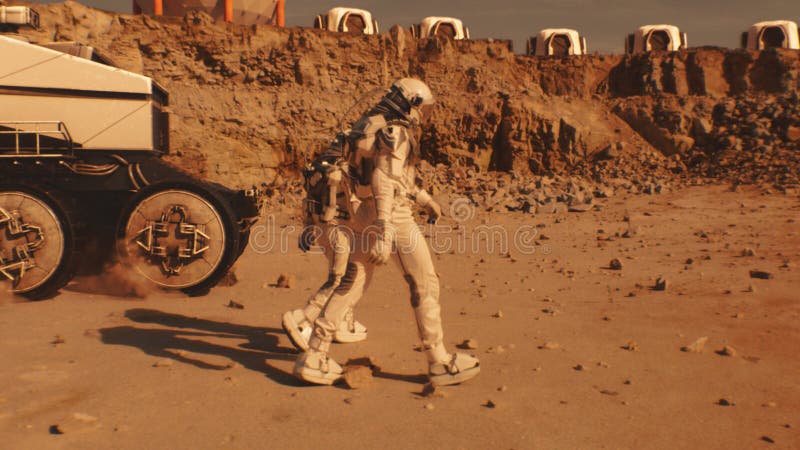 Two astronauts walk toward scientific base on Mars stock images