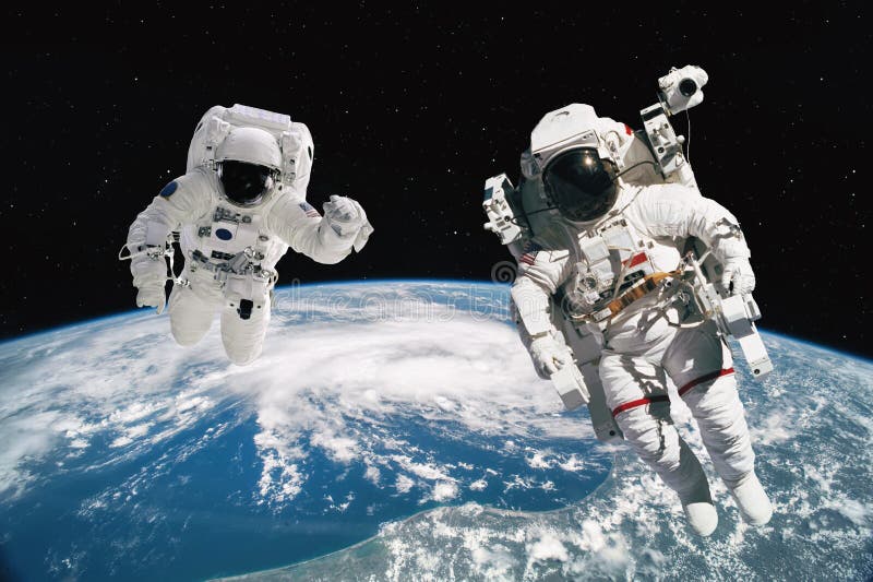 Two Astronauts Walking in Space with Earth Background. Elements of this