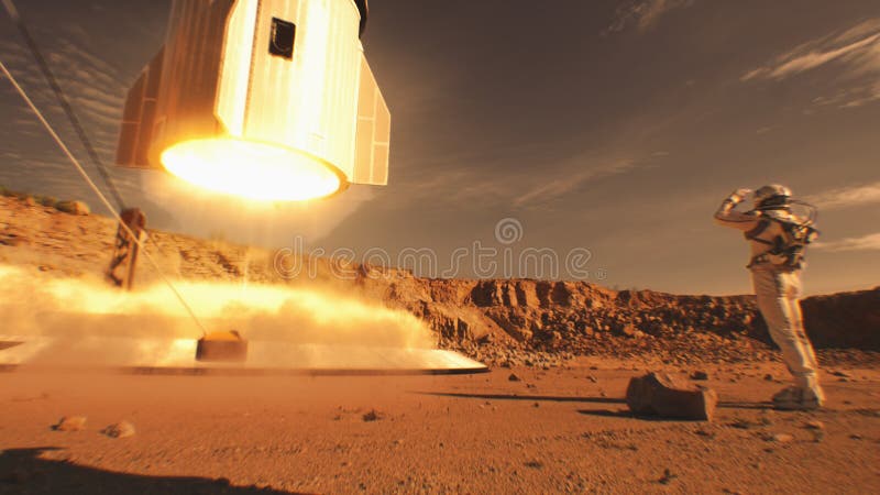 Two astronauts watch spacecraft landing on Mars surface royalty free stock image