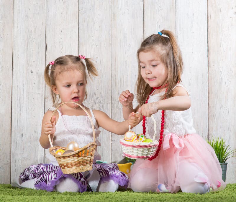 Two babes collect Easter eggs