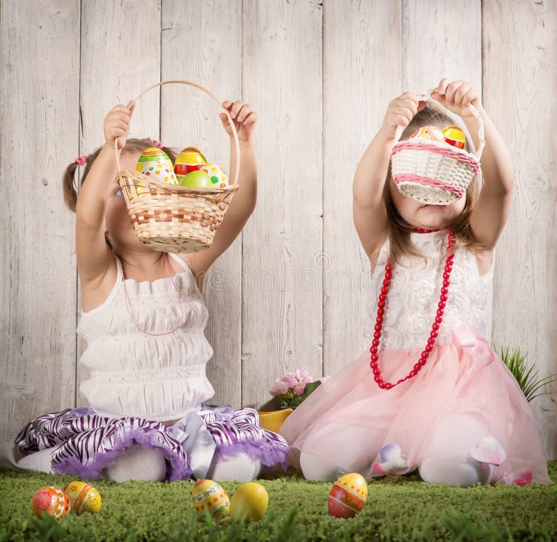 Two babes collect Easter eggs