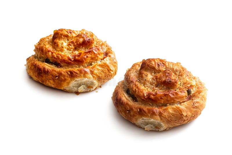 Two `Greek snail` buns, made of puff pastry, with a golden crust, on a white background