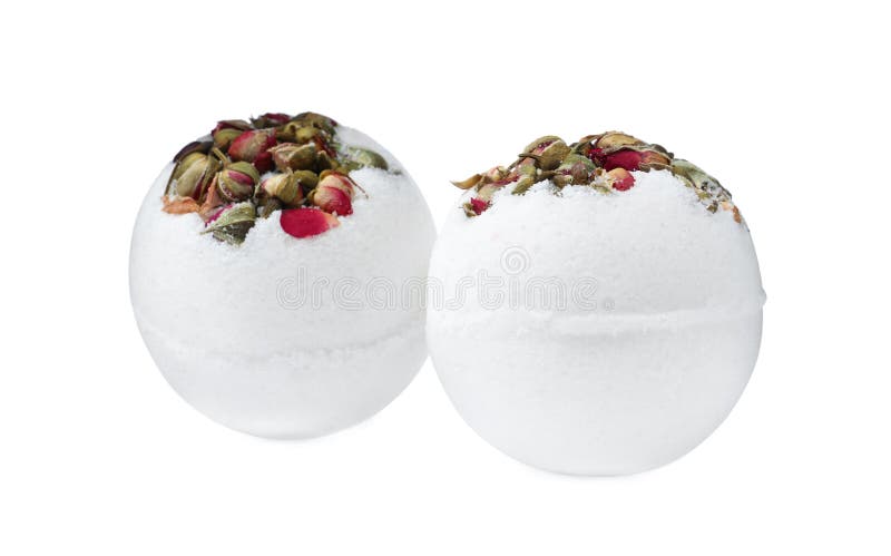 Two bath bombs with dried flowers on white background