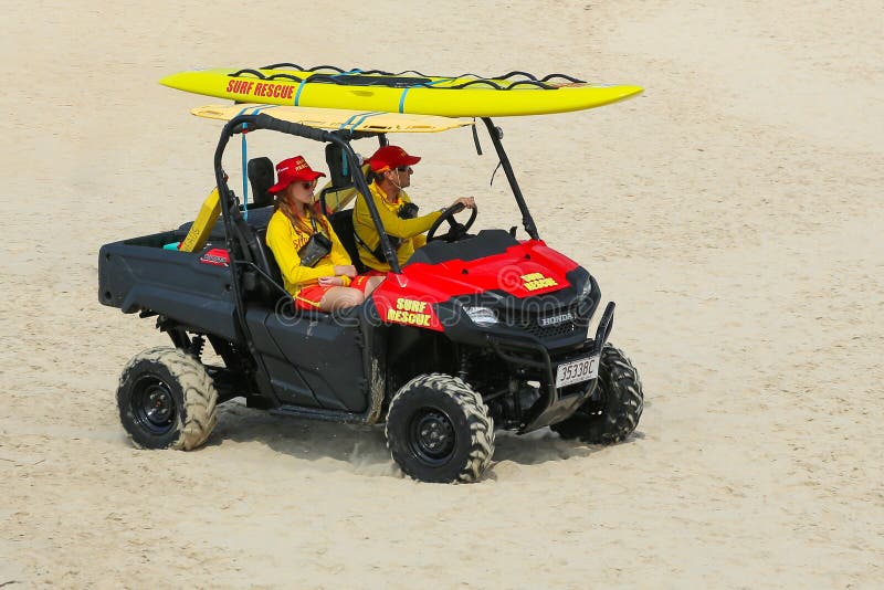 Two beach lifesavers in a surf patrol cart.