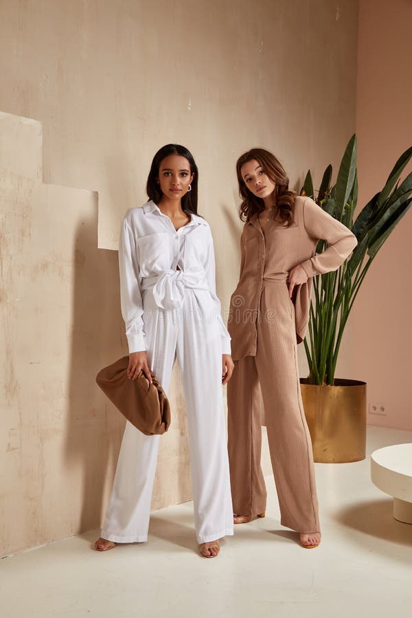 Two Beautiful Brunette Woman Friends Natural Make Up Wear Fashion Clothes  Casual Dress Code Office Style Blouse and Pants Suit for Stock Image -  Image of friend, casual: 180509945