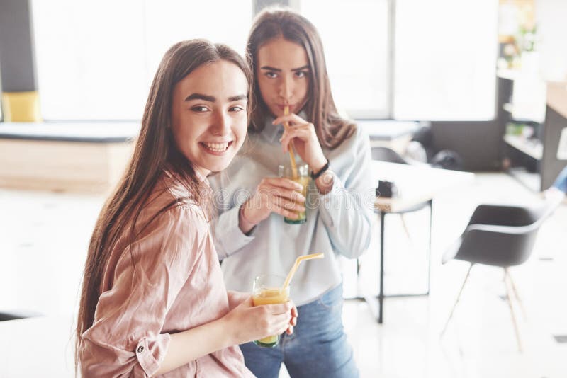 Two Beautiful Twin Girls Spend Time Drinking Juice Sisters Relaxing In