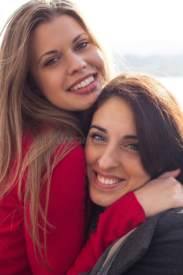 Two beautiful woman together enjoying the sunny autumn day