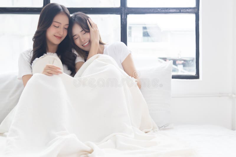 Two Beautiful Women Give Love While Sit On Bed Of Cozy Bedroom Lgbt