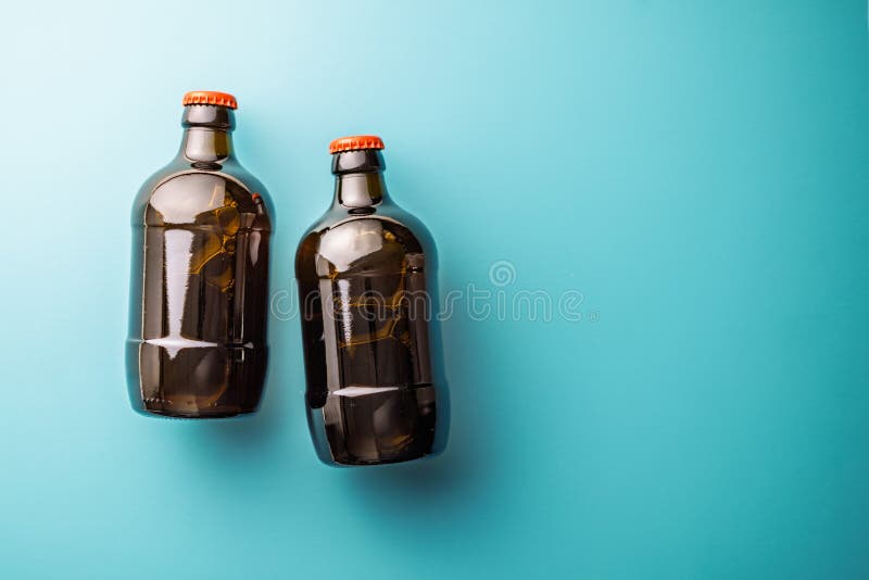 Two beer bottles on blue background. Top view stock photo