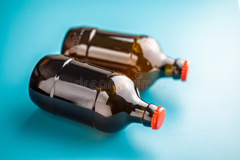 Two beer bottles on blue background stock photography