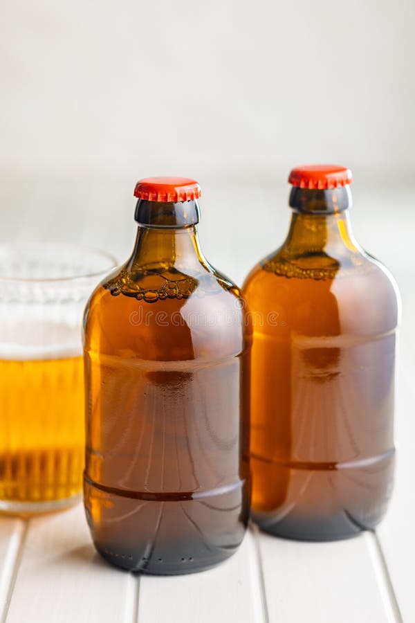 Two beer bottles on white table royalty free stock photo