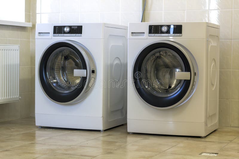 Two big washing machine in bathroom stock photos Two big washing machine in bathroom stock photos