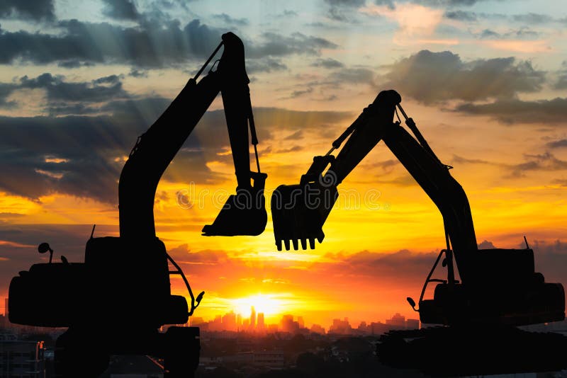 Two Black silhouette of backhoe loader with sunset light background,In cityscape