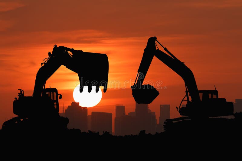 Two Black silhouette of excavator loader with sunset light background,In cityscape. Two Black silhouette of excavator loader with sunset light background,In cityscape