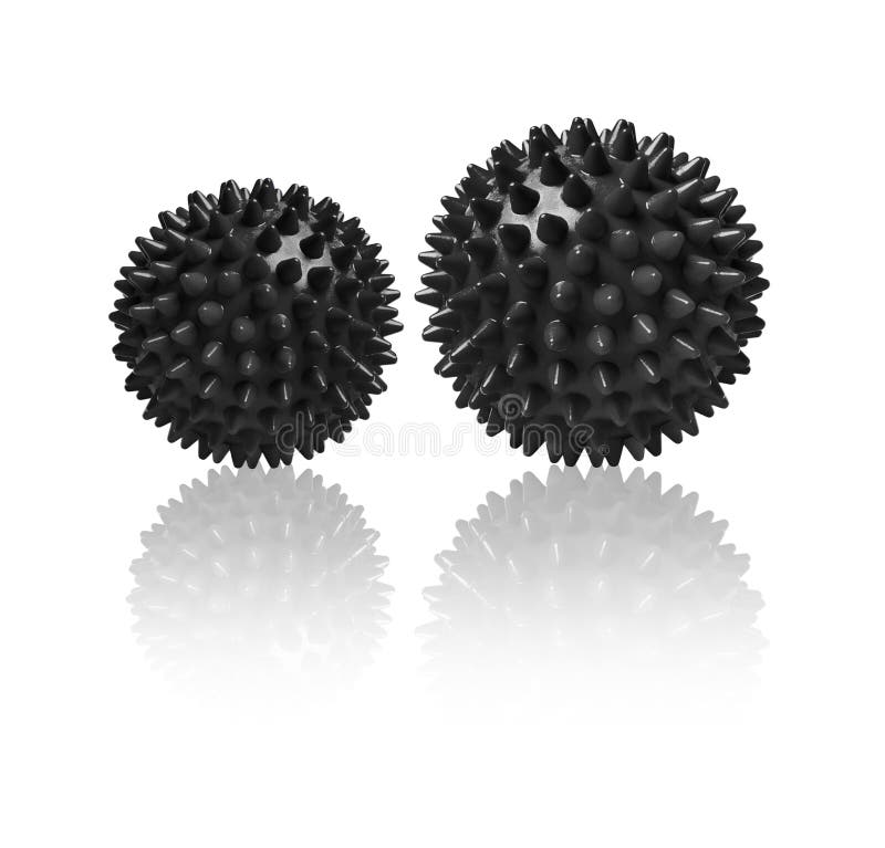 Two black spiny massage balls isolated on white. Concept of physiotherapy or fitness. Closeup of a colorful rubber ball for dog teeth on a white color background. Corona virus model. Snowflake.