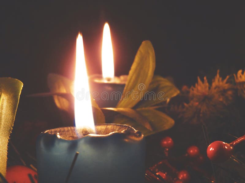 Two blue advent candles with decorations