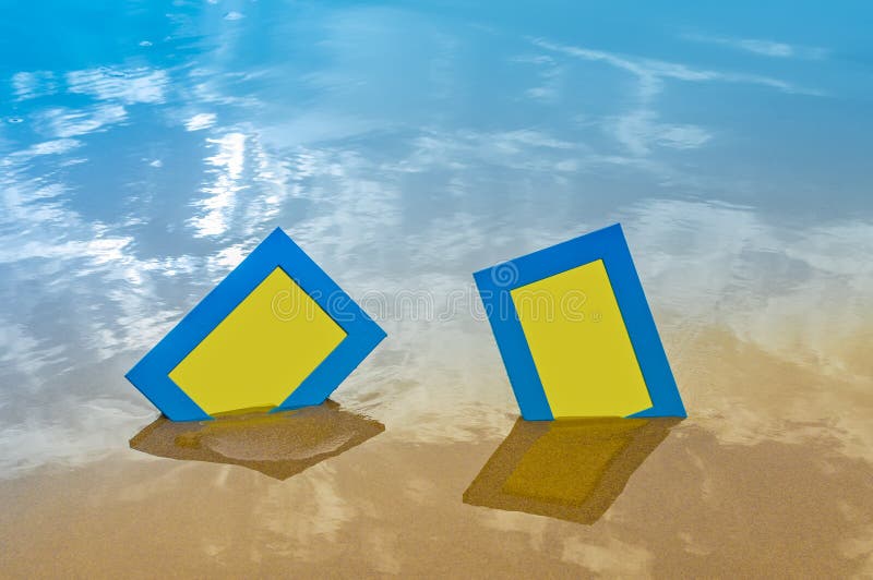 Two blue blank photo frames on the sand beach stock photography
