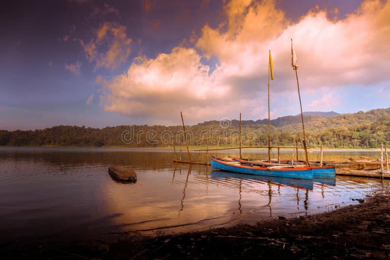 Two traditional Balinese fishing boats on the shore of Lake Tamblingan at sunset in Bali, Indonesia, Asia stock photos Two traditional Balinese fishing boats on the shore of Lake Tamblingan at sunset in Bali, Indonesia, Asia stock photos