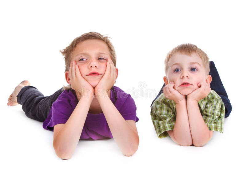 Two bored kids lying on the white background. Boring kid white stock images, royalty-free photos and pictures