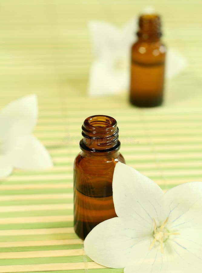 Two Bottles of Essence Oil and Flowers. Stock Photo Image of