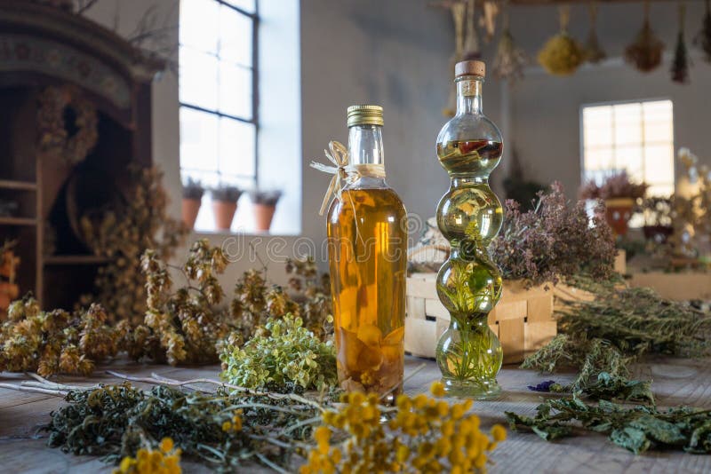 Two bottles with oil on a table with dried herbs and flowers royalty free stock photo Two bottles with oil on a table with dried herbs and flowers royalty free stock photo