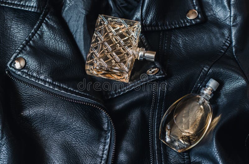 Two Bottles of Women S Perfume on a Black Leather Jacket Stock Photo